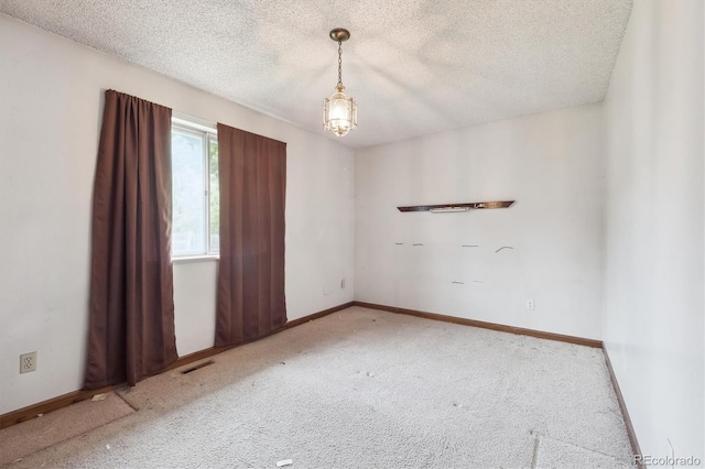 5935 Blanca Ct, Golden, CO 80403 - carpeted empty room featuring a textured ceiling and a chandelier