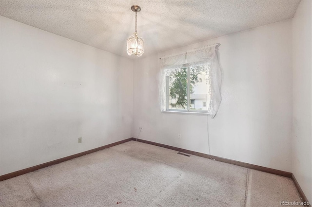 5935 Blanca Ct, Golden, CO 80403 - spare room with carpet floors, a chandelier, and a textured ceiling