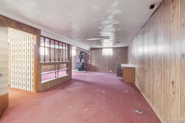 5935 Blanca Ct, Golden, CO 80403 - basement with a wood stove, wooden walls, and carpet flooring