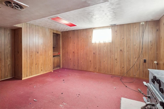 5935 Blanca Ct, Golden, CO 80403 - below grade area featuring wood walls, a textured ceiling, and carpet flooring
