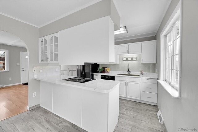 2971 S Sheridan Blvd, Denver, CO 80227 - kitchen featuring a sink, black appliances, glass insert cabinets, white cabinets, and ornamental molding