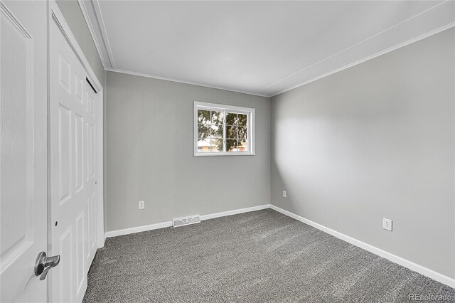2971 S Sheridan Blvd, Denver, CO 80227 - unfurnished bedroom featuring dark colored carpet, crown molding, baseboards, and a closet