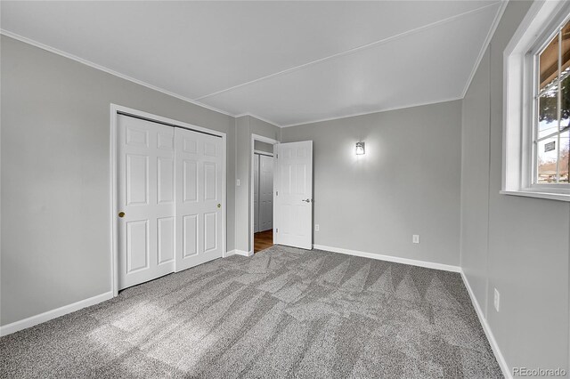 2971 S Sheridan Blvd, Denver, CO 80227 - unfurnished bedroom with carpet flooring, baseboards, crown molding, and a closet