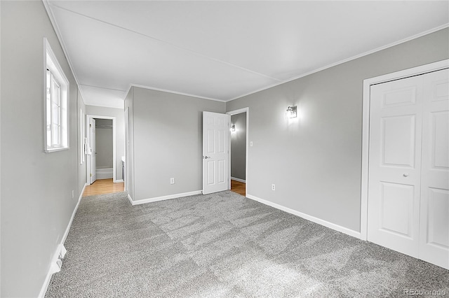 2971 S Sheridan Blvd, Denver, CO 80227 - unfurnished bedroom featuring carpet floors, baseboards, crown molding, and a closet