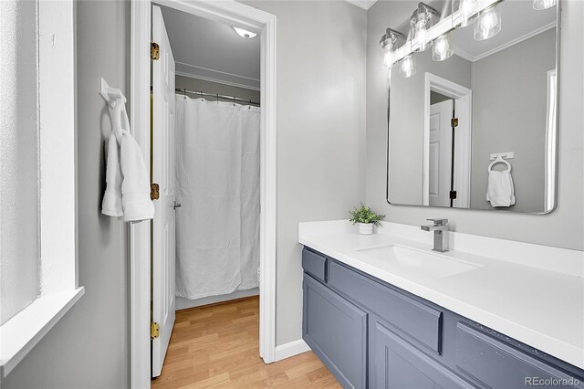 2971 S Sheridan Blvd, Denver, CO 80227 - full bath with wood finished floors, vanity, and crown molding