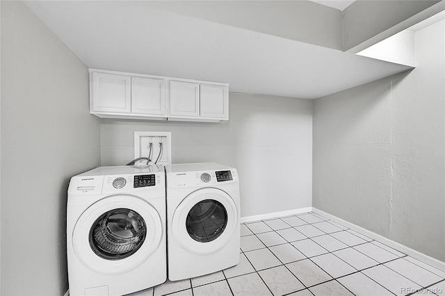 2971 S Sheridan Blvd, Denver, CO 80227 - laundry area featuring washer and dryer, cabinet space, light tile patterned flooring, and baseboards