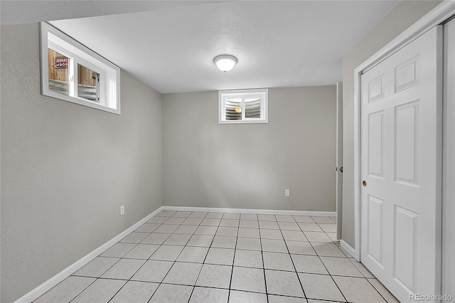 2971 S Sheridan Blvd, Denver, CO 80227 - basement featuring light tile patterned flooring, a textured ceiling, and baseboards