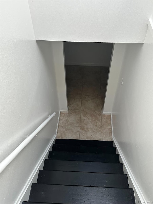 stairs with tile patterned floors