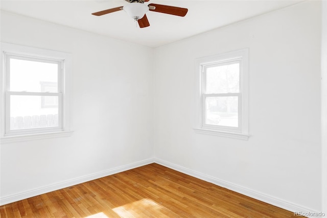 empty room with baseboards, light wood-style floors, and ceiling fan