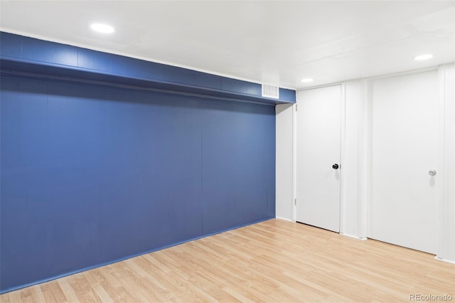 finished basement featuring light wood-style floors and recessed lighting