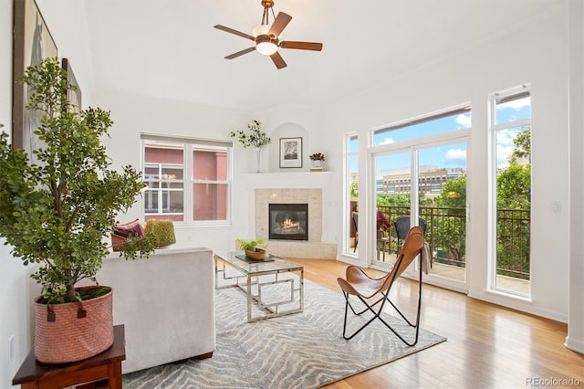 2100 N Humboldt St Unit 302, Denver, CO 80205 - living room with healthy amount of natural light, ceiling fan, wood finished floors, and a tiled fireplace