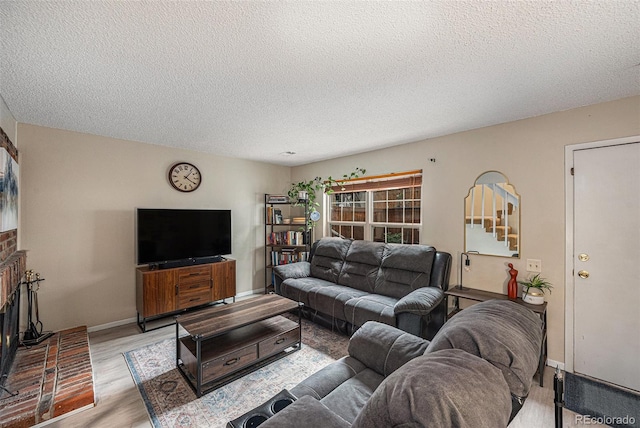 6937 S Knolls Way, Centennial, CO 80122 - living area with a textured ceiling, wood finished floors, a brick fireplace, and baseboards