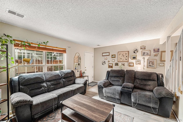 6937 S Knolls Way, Centennial, CO 80122 - living room with light wood-type flooring and a textured ceiling