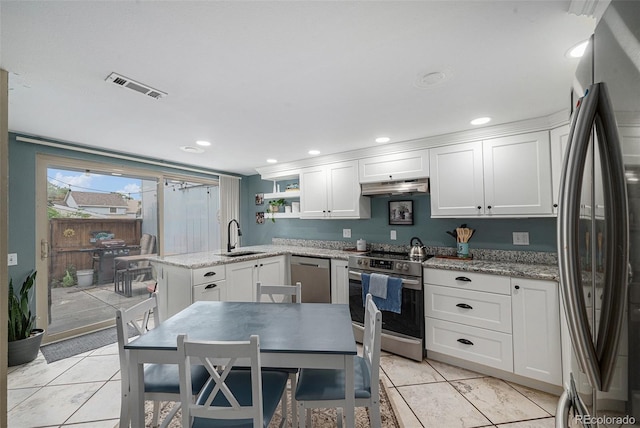 6937 S Knolls Way, Centennial, CO 80122 - kitchen featuring appliances with stainless steel finishes, under cabinet range hood, a sink, white cabinetry, and light tile patterned flooring