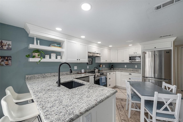 6937 S Knolls Way, Centennial, CO 80122 - kitchen featuring appliances with stainless steel finishes, a sink, a peninsula, white cabinetry, and under cabinet range hood