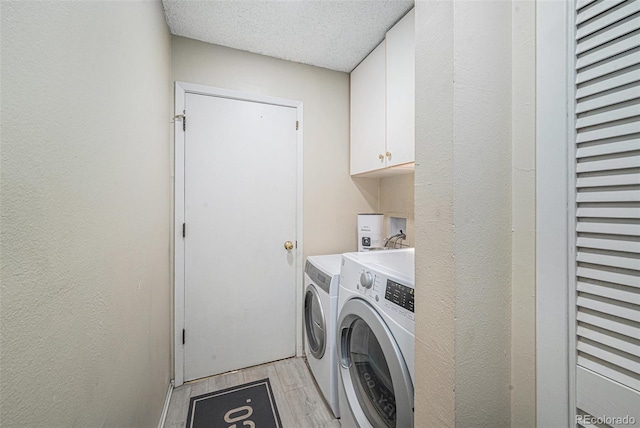 6937 S Knolls Way, Centennial, CO 80122 - laundry room with washer and dryer, cabinet space, a textured ceiling, and light wood finished floors