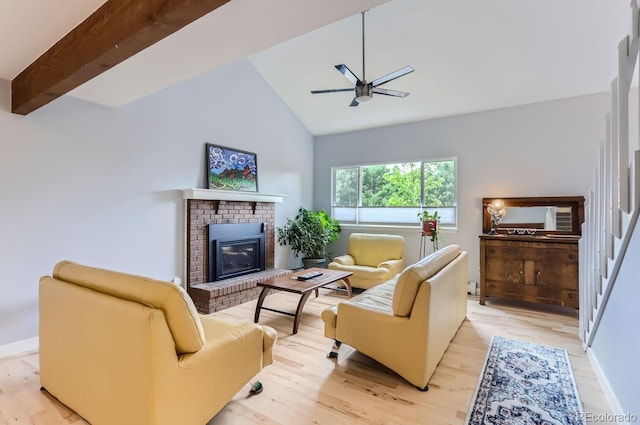 living room featuring high vaulted ceiling, light hardwood / wood-style flooring, a brick fireplace, ceiling fan, and beam ceiling