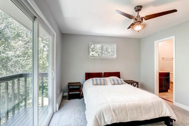 carpeted bedroom featuring a baseboard heating unit, access to outside, ensuite bathroom, and ceiling fan