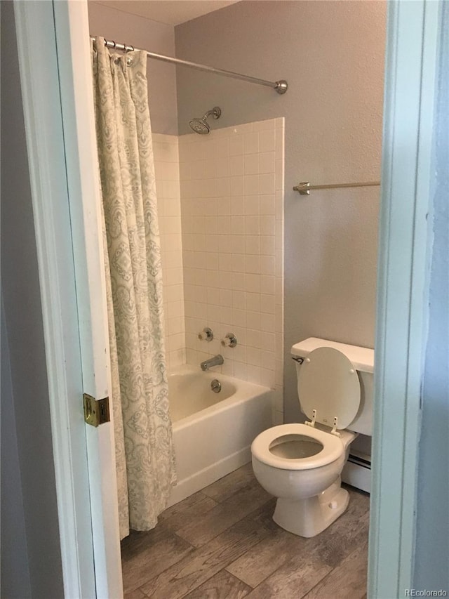 bathroom with baseboard heating, toilet, wood-type flooring, and shower / bath combo with shower curtain