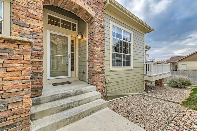 doorway to property featuring stone siding