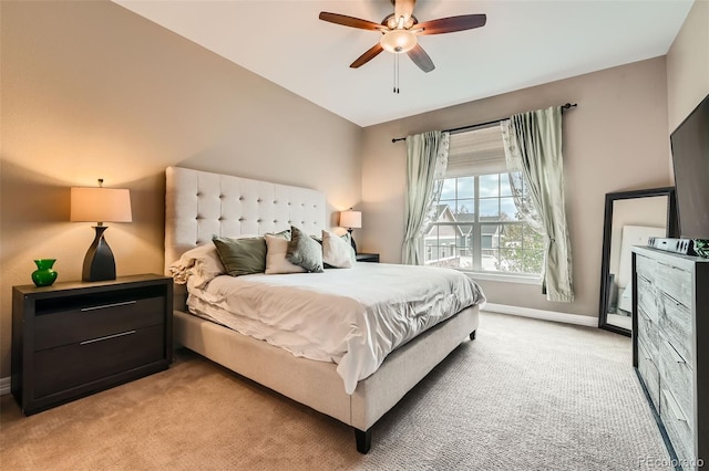 bedroom with a ceiling fan, light colored carpet, and baseboards