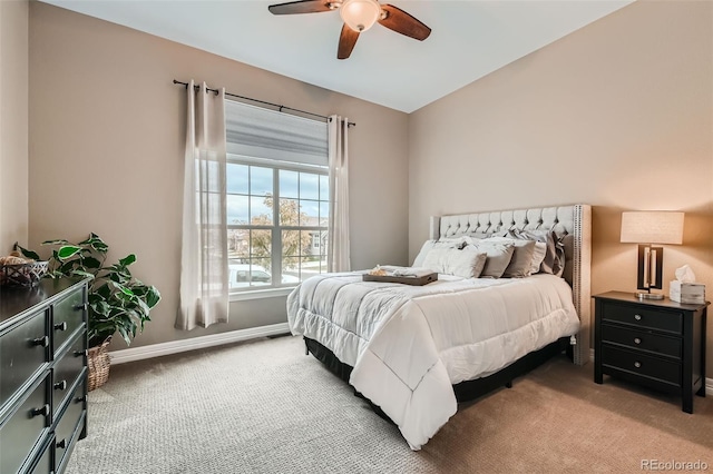 bedroom featuring baseboards, ceiling fan, and light colored carpet