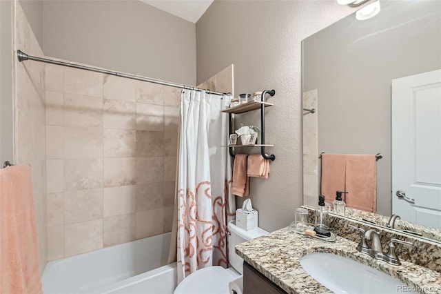 bathroom with a textured wall, vanity, toilet, and shower / tub combo with curtain