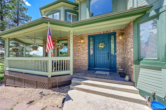 6681 Flintwood Rd, Parker, CO 80138 - doorway to property with brick siding and covered porch