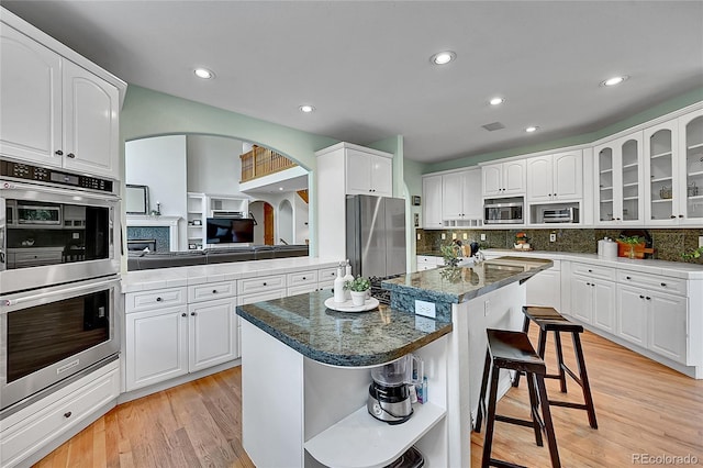 6681 Flintwood Rd, Parker, CO 80138 - kitchen featuring stainless steel appliances, open shelves, a kitchen island, tasteful backsplash, and recessed lighting