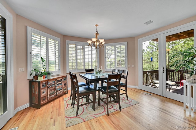 6681 Flintwood Rd, Parker, CO 80138 - dining area featuring a chandelier, light wood-type flooring, and french doors