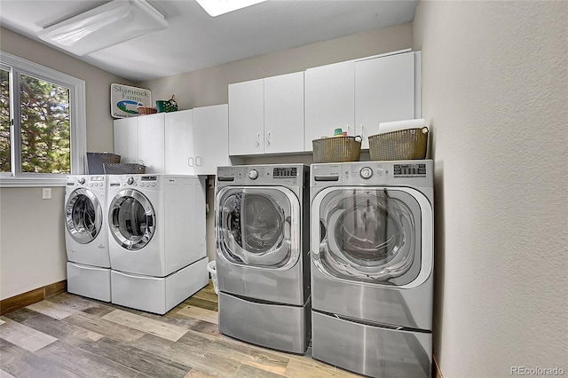 6681 Flintwood Rd, Parker, CO 80138 - laundry area with washer and clothes dryer, cabinet space, and light wood-style floors