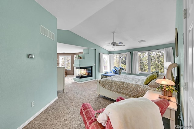 6681 Flintwood Rd, Parker, CO 80138 - carpeted bedroom featuring lofted ceiling, a multi sided fireplace, and a ceiling fan