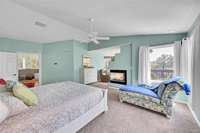 6681 Flintwood Rd, Parker, CO 80138 - bedroom with carpet floors, lofted ceiling, a multi sided fireplace, a ceiling fan, and ensuite bath