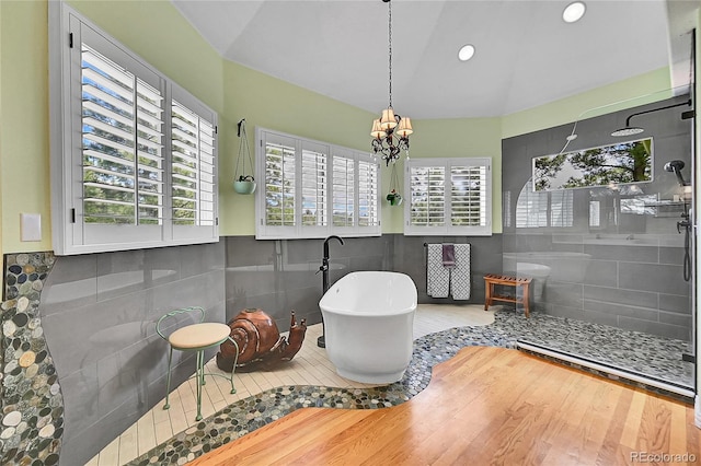 6681 Flintwood Rd, Parker, CO 80138 - bathroom with a freestanding bath, a chandelier, tiled shower, wood finished floors, and recessed lighting