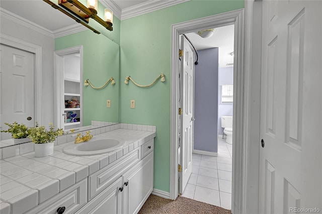 6681 Flintwood Rd, Parker, CO 80138 - bathroom with vanity, tile patterned flooring, ornamental molding, and a closet