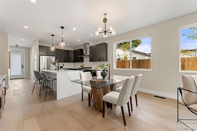 dining room with visible vents, baseboards, light wood-type flooring, recessed lighting, and a notable chandelier