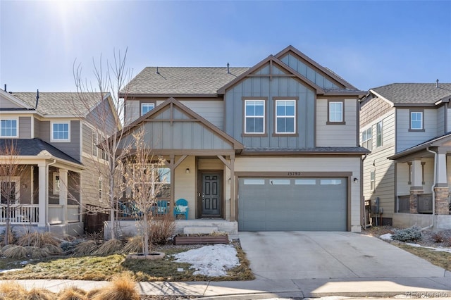 craftsman inspired home with a garage and covered porch