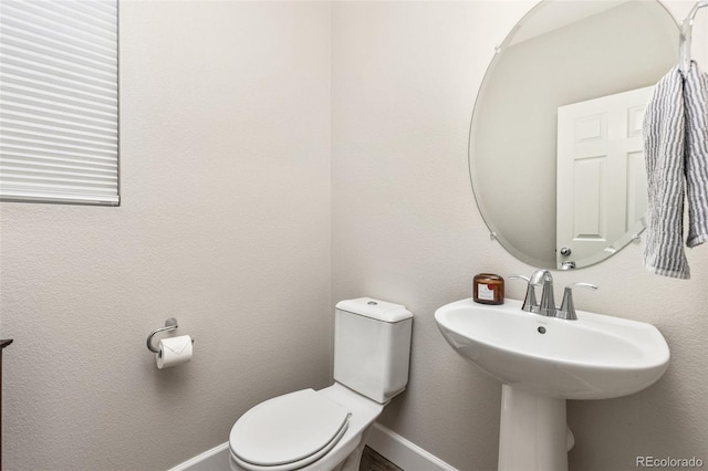 bathroom featuring toilet and sink