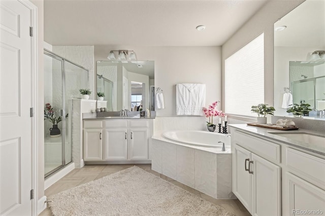 bathroom featuring plenty of natural light, separate shower and tub, and vanity