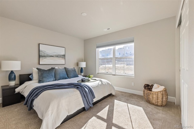 bedroom with light colored carpet and a closet