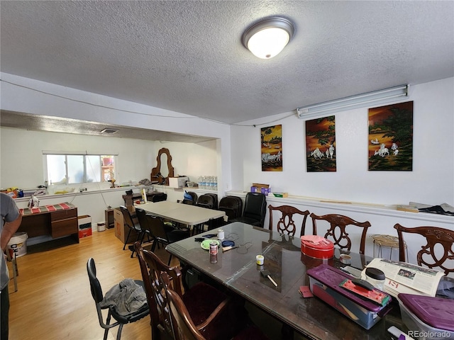 3341 E 99th Way, Thornton, CO 80229 - dining space featuring a textured ceiling and light wood-style floors