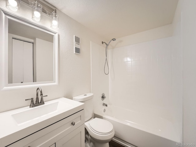 bathroom featuring visible vents, a textured wall, toilet, tub / shower combination, and vanity