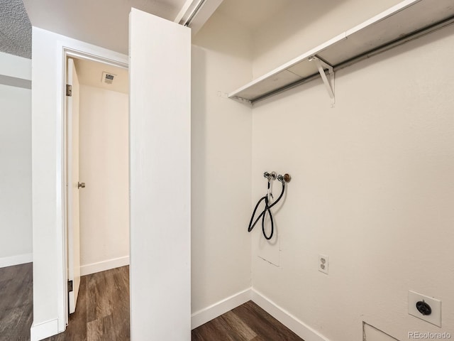 washroom with dark wood-type flooring, washer hookup, electric dryer hookup, and baseboards