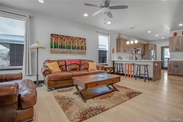 1111 E St, Salida, CO 81201 - living area featuring light wood finished floors, a ceiling fan, and recessed lighting