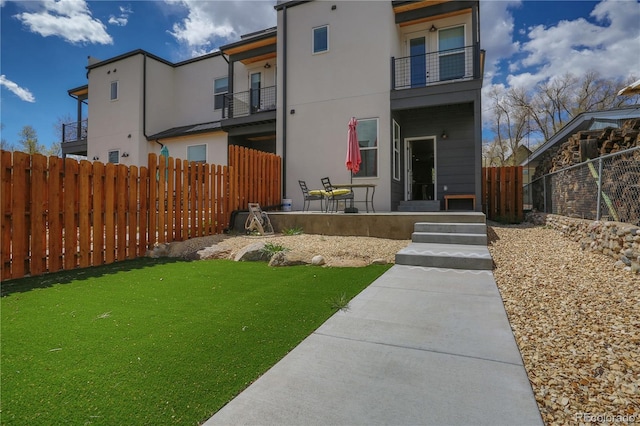 1111 E St, Salida, CO 81201 - rear view of house with a balcony and stucco siding