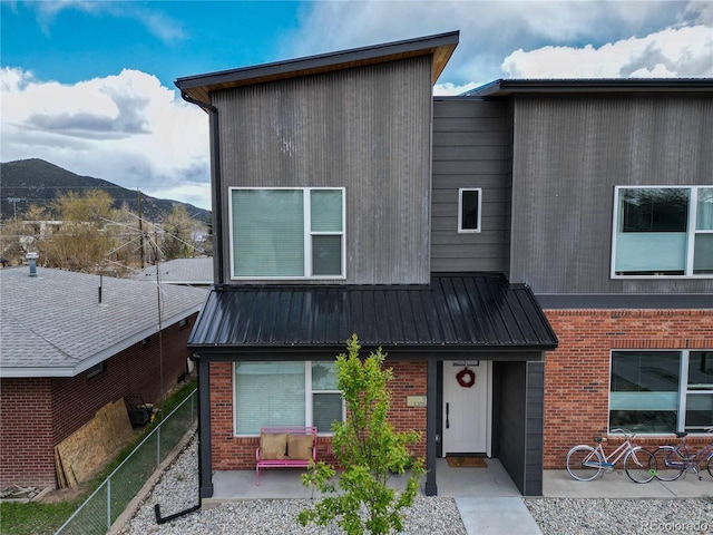 1111 E St, Salida, CO 81201 - contemporary home featuring brick siding, a mountain view, and a metal roof