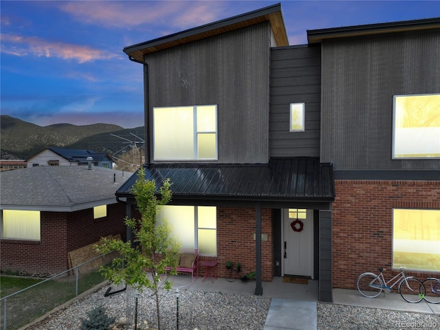 1111 E St, Salida, CO 81201 - contemporary house with brick siding, a metal roof, and a mountain view