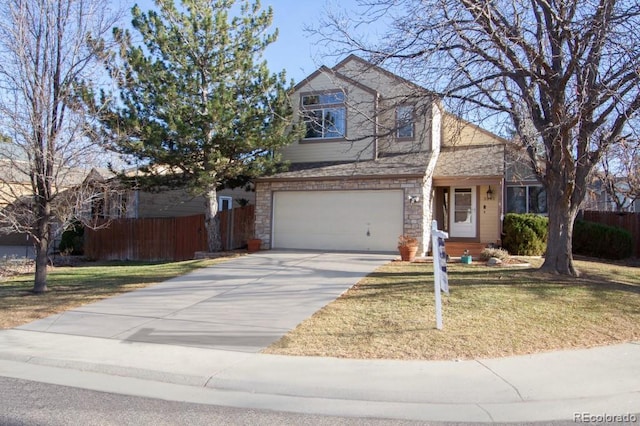 traditional-style house featuring an attached garage, fence, driveway, stone siding, and a front yard