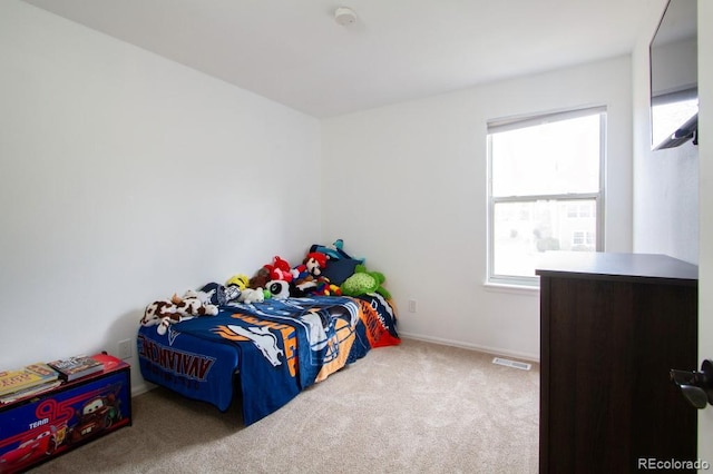 carpeted bedroom featuring visible vents