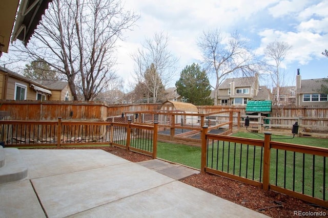 view of patio featuring a playground and a fenced backyard